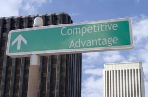 Street sign with an arrow and the words "competitive advantage" located in a business district.