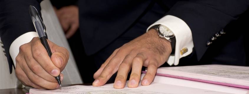 businessman filling out paperwork